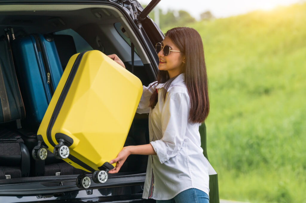 Loading suitcase into private hire car for cruise port transfer from Essex